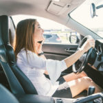 Young lady on the phone while driving Young lady on the phone while driving