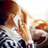 buiness woman talking on phone while driving