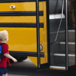 Little boy getting on school bus Little boy getting on school bus