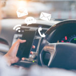 Man using smartphone while driving the car Man using smartphone while driving the car