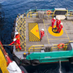 Maritime workers are transported on a vessel to offshore rigs in The South China Sea Maritime workers are transported on a vessel to offshore rigs in The South China Sea