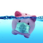 Piggy bank Wearing A Protective Face Mask Drowning In Underwater - Protection Concept And Savings To Risk