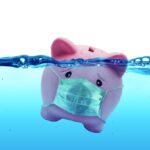 Piggy bank Wearing A Protective Face Mask Drowning In Underwater - Protection Concept And Savings To Risk Piggy bank Wearing A Protective Face Mask Drowning In Underwater - Protection Concept And Savings To Risk