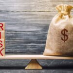 Money bag and wooden blocks with the word Risk. The concept of financial risk. Justified risks. Investing in a business project. Making the right decision. Property insurance. Legal and market risks Money bag and wooden blocks with the word Risk. The concept of financial risk. Justified risks. Investing in a business project. Making the right decision. Property insurance. Legal and market risks