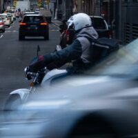 A motorcycle courier riding in the city