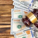 Judge's gavel with dollar bills on the table. Top view. Judge's gavel with dollar bills on the table. Top view.