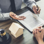 Real estate attorney consulting with client Real estate attorney consulting with client