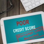 TOP VIEW OF WHITE TABLET SHOWING MORTGAGE LOAN REJECTION BECAUSE OF POOR CREDIT SCORE WITH COMPUTER KEYBOARD, EYE GLASSES, AND A CALCULATOR ON WOODEN TABLE TOP VIEW OF WHITE TABLET SHOWING MORTGAGE LOAN REJECTION BECAUSE OF POOR CREDIT SCORE WITH COMPUTER KEYBOARD, EYE GLASSES, AND A CALCULATOR ON WOODEN TABLE