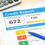 Fair credit score report with pen and calculator