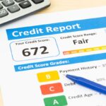 Fair credit score report with pen and calculator Fair credit score report with pen and calculator