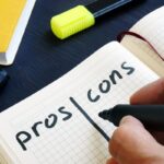 Man is writing list of pros and cons. Man is writing list of pros and cons.